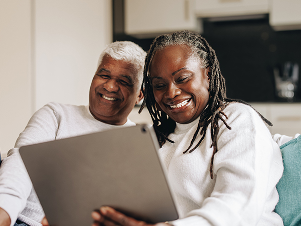 Couple on computer smiling together