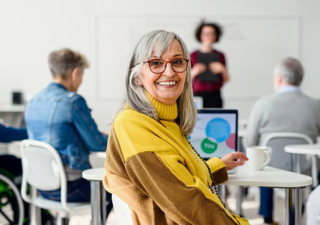 Senior woman smiling while in a classroom setting