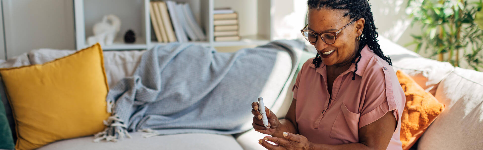 A woman checking her blood sugar at home