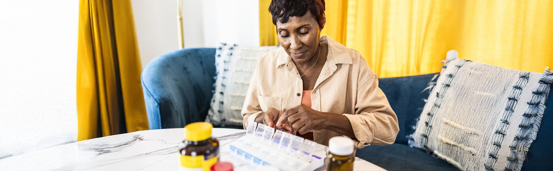 A woman organizing her medicine into a pill organizer